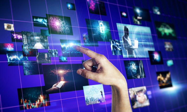 Hand interacting with a digital wall of AI-powered multimedia and motion graphics.