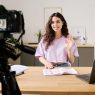 Woman recording an educational video at home studio setup.